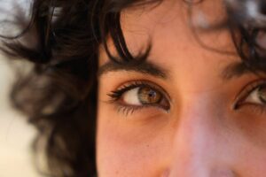 An artistic close-up image capturing the vivid detail and natural beauty of eyes with reflective light.